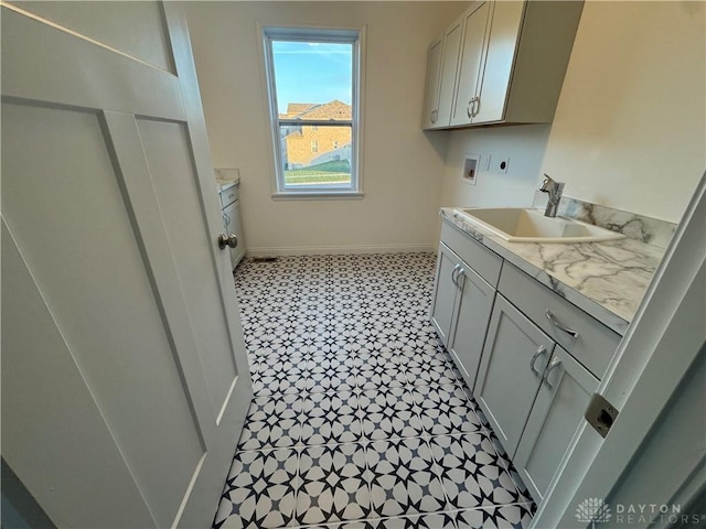 washroom featuring cabinets, hookup for a washing machine, hookup for an electric dryer, and sink