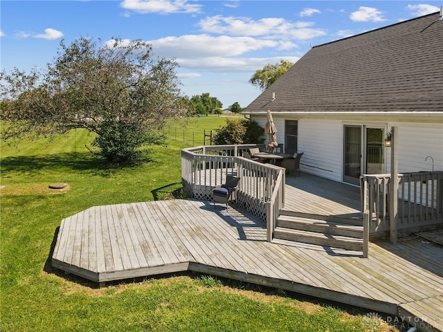 wooden deck featuring a yard