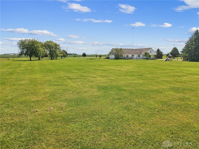 view of yard with a playground and a rural view