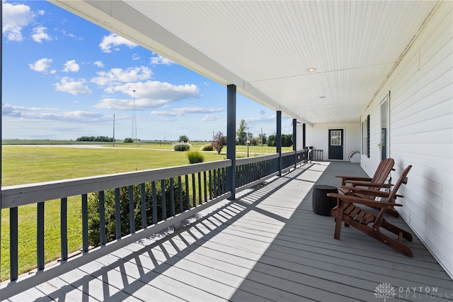 wooden deck featuring a lawn