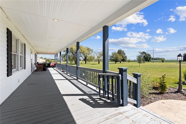 wooden terrace with a lawn