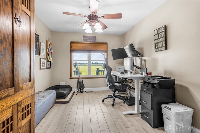 office area with light hardwood / wood-style flooring and ceiling fan