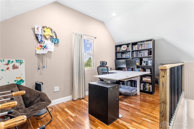 office featuring light wood-type flooring and lofted ceiling