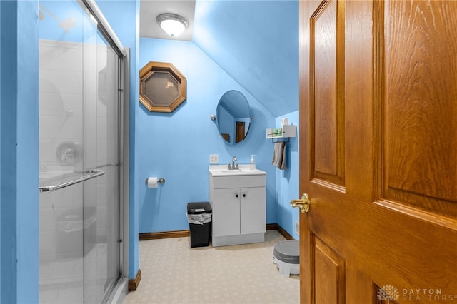 bathroom featuring toilet, walk in shower, tile patterned floors, vanity, and vaulted ceiling