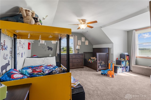 carpeted bedroom featuring ceiling fan and vaulted ceiling