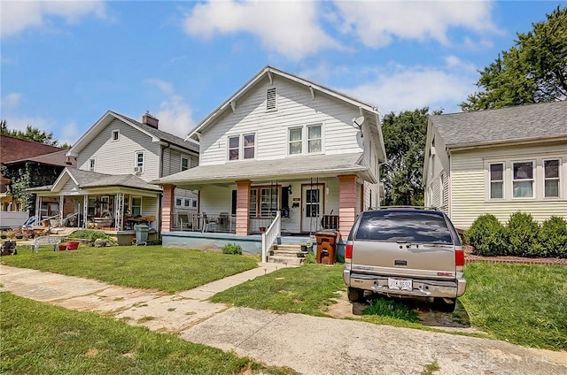 view of front of house featuring covered porch and a front lawn