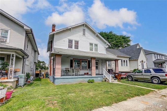 view of front of home featuring a front yard and covered porch