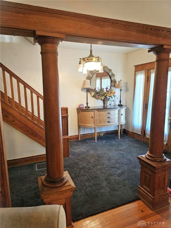 dining room with decorative columns and hardwood / wood-style flooring