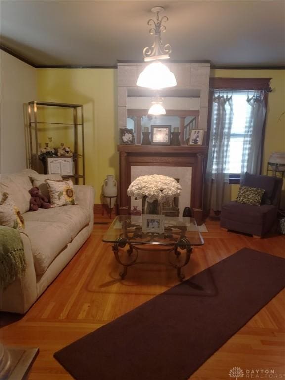 living room with hardwood / wood-style flooring and ornamental molding