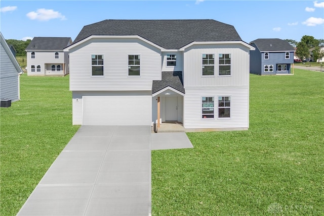 view of front property featuring a garage and a front yard