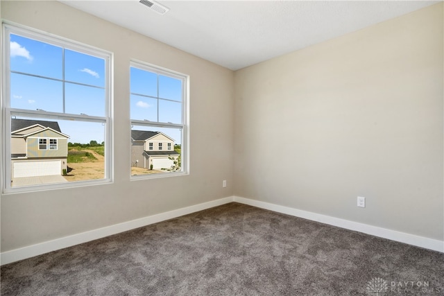 carpeted empty room featuring plenty of natural light