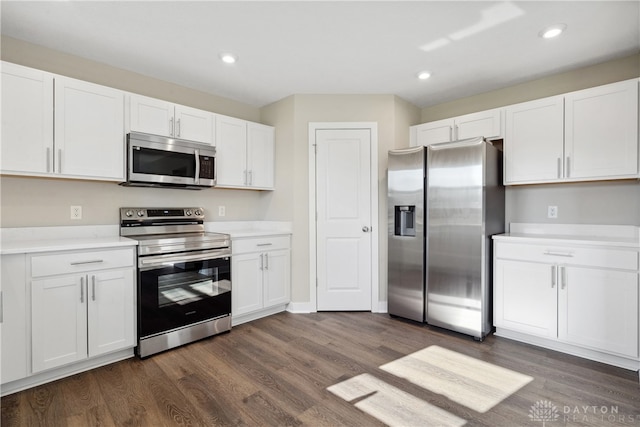 kitchen featuring dark wood-type flooring, appliances with stainless steel finishes, and white cabinetry