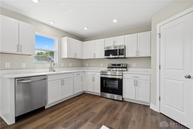 kitchen featuring sink, dark hardwood / wood-style floors, appliances with stainless steel finishes, and white cabinetry