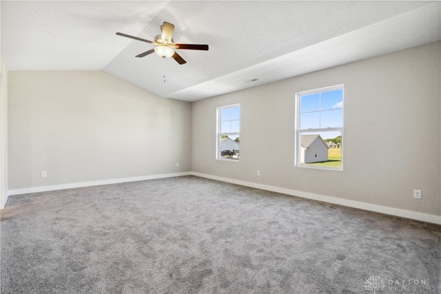 unfurnished room with lofted ceiling, ceiling fan, and carpet floors