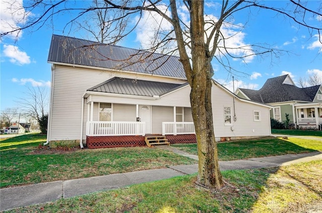 bungalow-style home featuring covered porch and a front yard