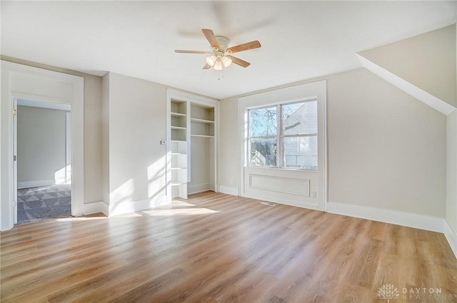 additional living space with vaulted ceiling, light hardwood / wood-style flooring, and ceiling fan