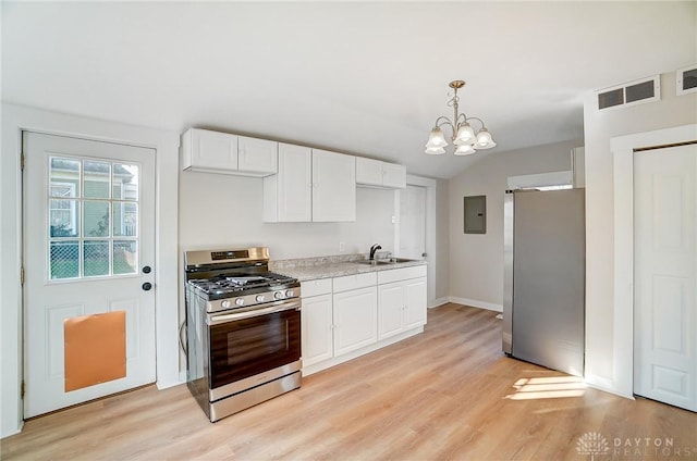 kitchen with hanging light fixtures, appliances with stainless steel finishes, light hardwood / wood-style floors, white cabinetry, and a chandelier