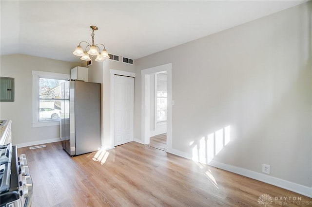 kitchen with electric panel, appliances with stainless steel finishes, a chandelier, white cabinets, and light wood-type flooring