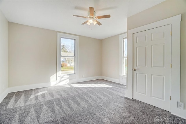 spare room with light carpet and ceiling fan