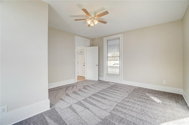 empty room featuring light carpet and ceiling fan