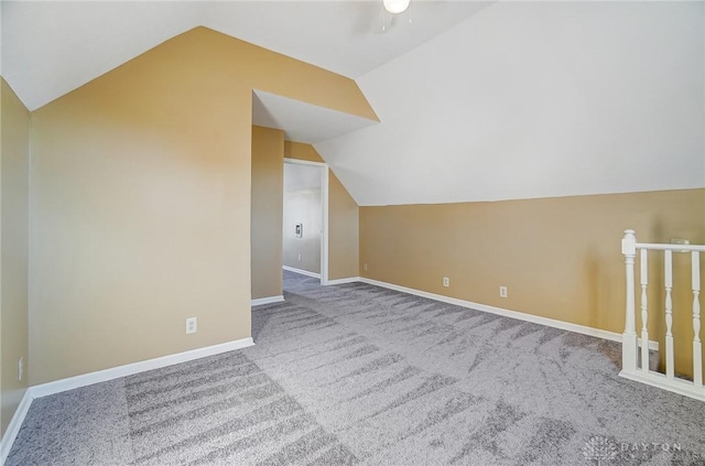 additional living space with carpet flooring, ceiling fan, and vaulted ceiling