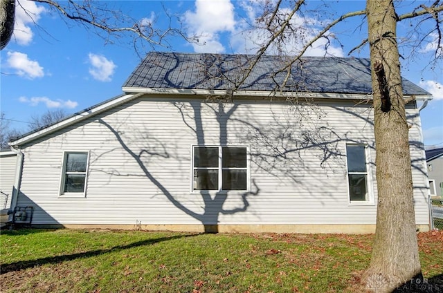 view of property exterior featuring a lawn