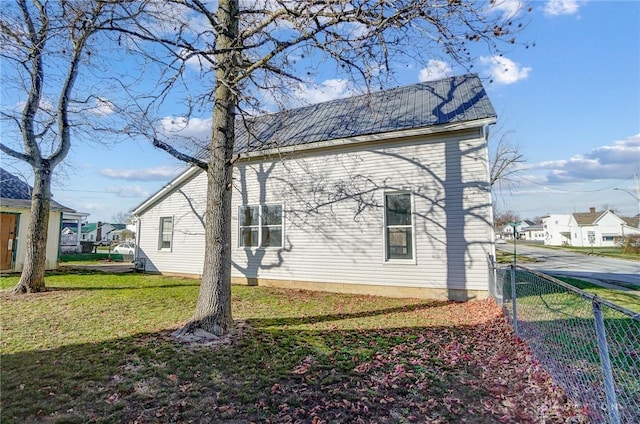 view of property exterior with a lawn