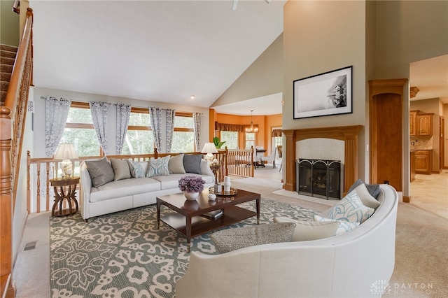 living room with light carpet, high vaulted ceiling, and a wealth of natural light