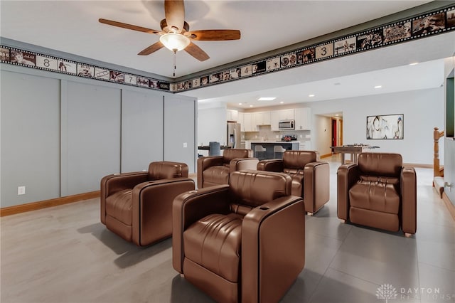 home theater featuring light tile patterned flooring and ceiling fan