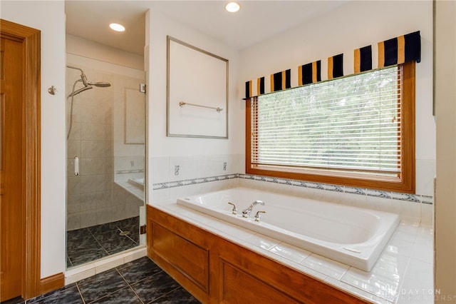 bathroom with tile patterned flooring, plus walk in shower, and a wealth of natural light