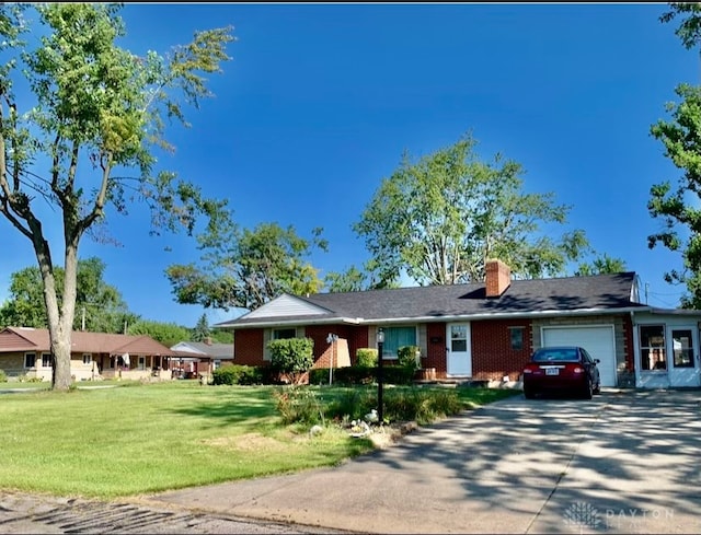 ranch-style home with a front lawn and a garage