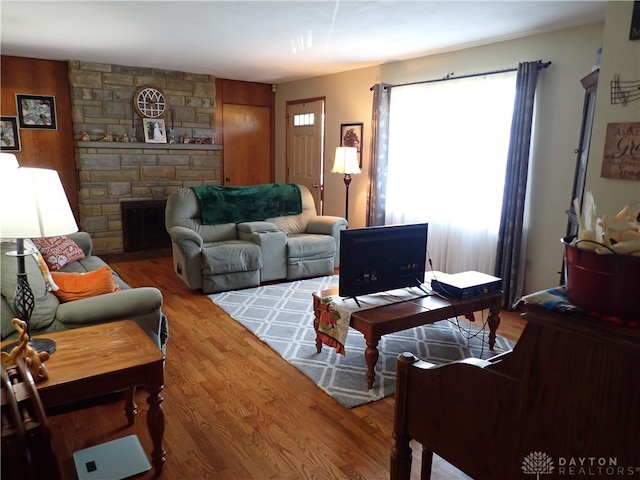 living room with hardwood / wood-style flooring and a fireplace