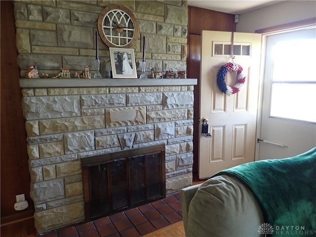 interior space with dark tile patterned floors and a fireplace