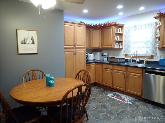 kitchen featuring stainless steel dishwasher, sink, dark tile patterned floors, and ceiling fan