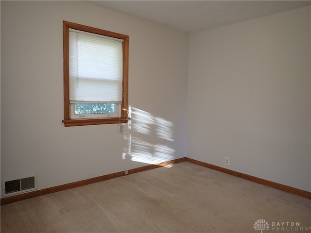 unfurnished room with light carpet