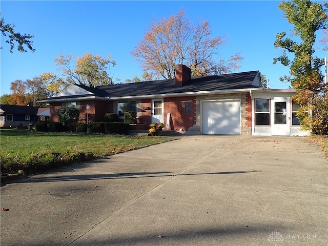 single story home featuring a front lawn and a garage