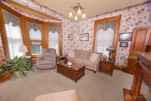 living room with a notable chandelier and light carpet