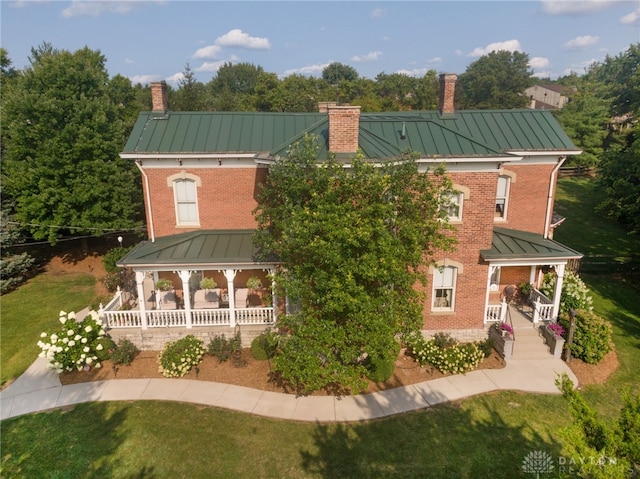 rear view of house featuring covered porch