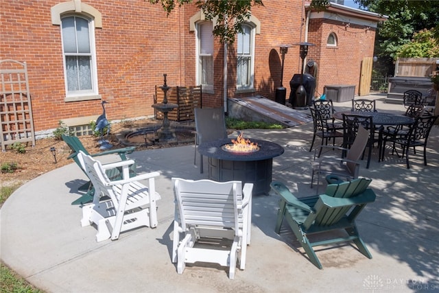 view of patio / terrace featuring an outdoor fire pit