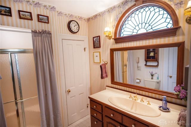 bathroom with vanity and a shower with shower door