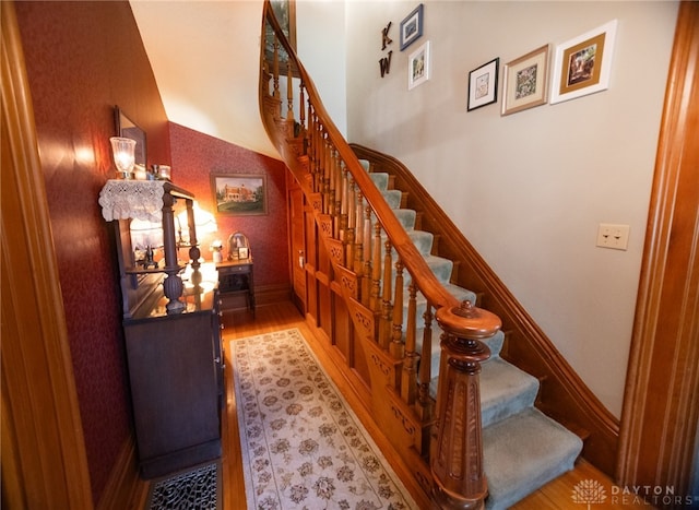 stairway with hardwood / wood-style floors