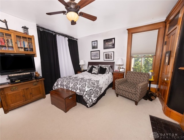 bedroom featuring light colored carpet and ceiling fan