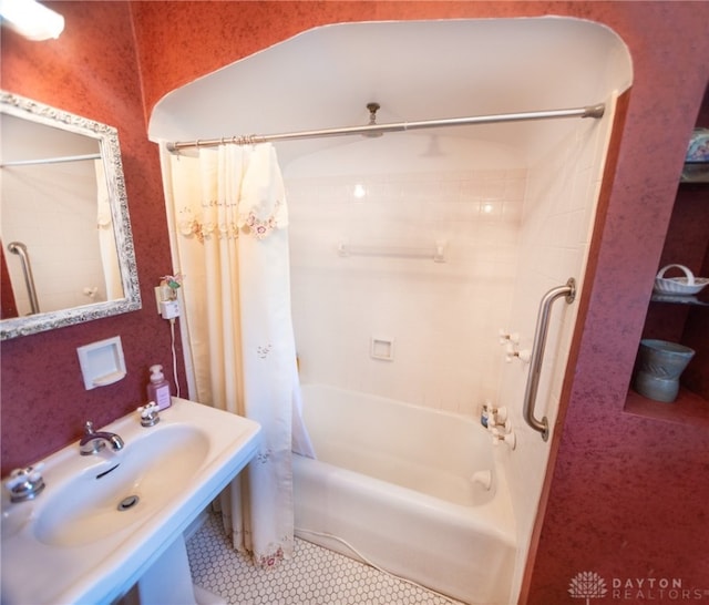 bathroom featuring tile patterned floors, shower / tub combo with curtain, and sink