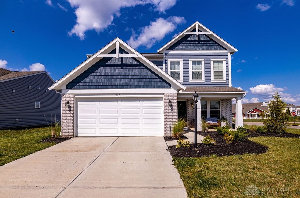 view of front of home featuring a front lawn and a garage