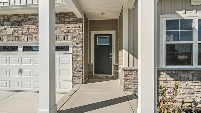 entrance to property with a porch and a garage