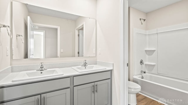 full bathroom with vanity, wood-type flooring, bathtub / shower combination, and toilet