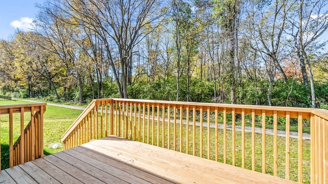 wooden terrace featuring a lawn