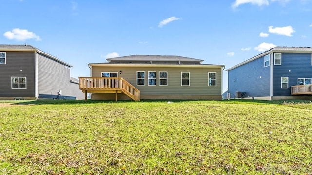 rear view of property with central AC unit, a yard, and a wooden deck