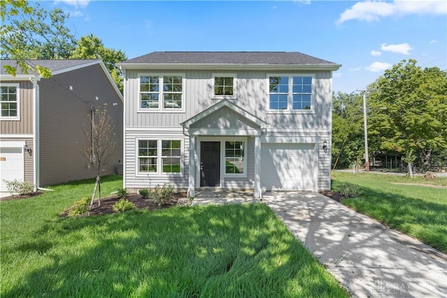 view of front of home with a garage and a front lawn