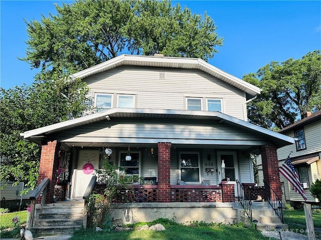 view of front of property with covered porch and brick siding